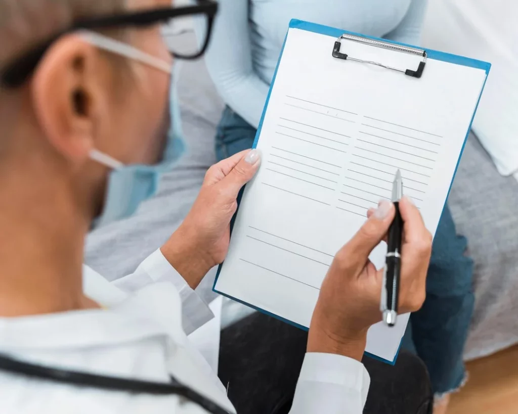 Doctor filling out treatment plan paperwork for delivery of medication